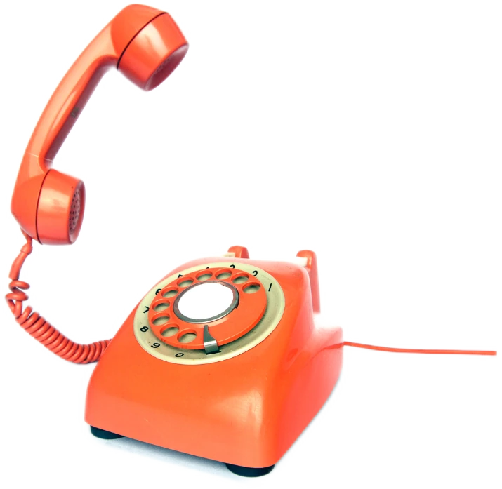 An orange rotary telephone with its handset lifted.